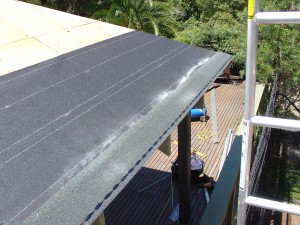 Completed line of asphalt roof shingle starter course Completed line of asphalt roof shingle starter course