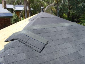 Courses of asphalt shingles running up the roof